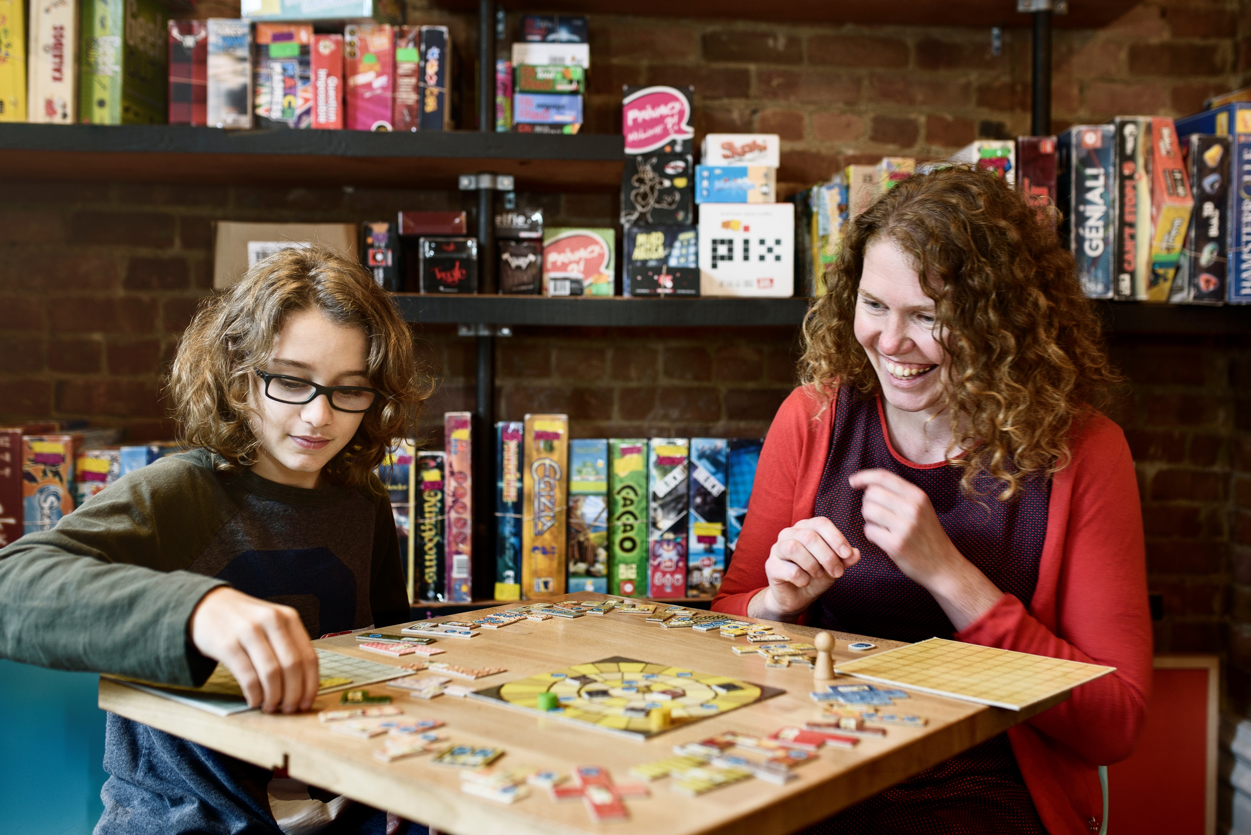 Little Brother and Big Sister playing a board game for the Board Game Drive