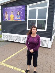 Maureen Cassivi winner of the 2021 Dream Cottage standing outside the Dream Cottage