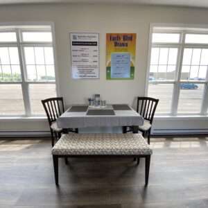 Table, chairs, bench, signage and windows